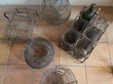 four baskets on the floor next to a bottle of wine