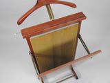 a wooden clothes rack with a wooden hanger on it
