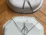 two plates with scissors on them sitting on the floor