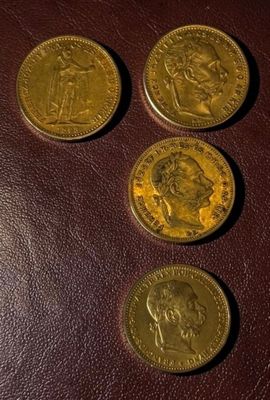four different coins sitting on top of a brown leather surface