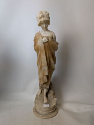 marble statue of a woman holding a book
