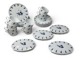 several pieces of blue and white dinnerware are arranged on a white surface