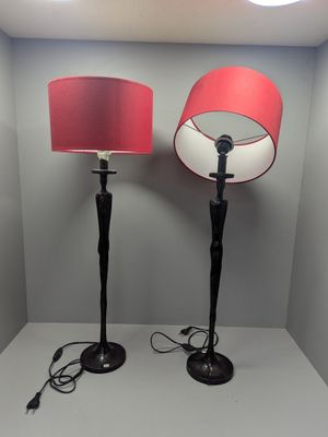 pair of black and red floor lamps with red lampshads