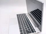 a white laptop with a black keyboard on a white surface