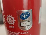 a red fire extinguisor sitting on a table