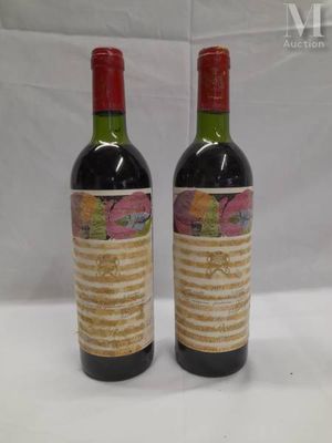 two bottles of wine sitting on top of a table next to each other