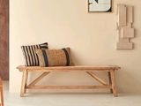 a wooden bench in the middle of a living room