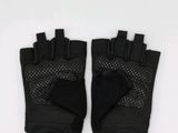 a pair of black gloves sitting on top of a white surface