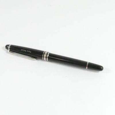 un stylo noir posé sur une surface blanche