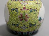 a vase with a design on it sitting on a table