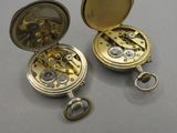 deux types différents de montres de poche posées sur la table