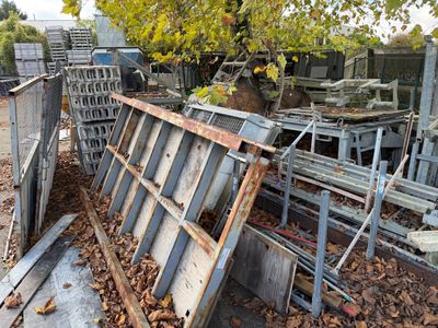 a pile of junk in the yard of a house