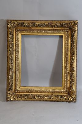 a gold frame with a white background and a white wall behind it