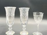 three wine glasses sitting next to each other on a table