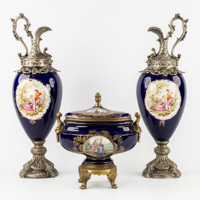 two blue vases with gold handles and a lid with a picture of a woman on them