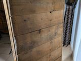 a wooden door that is open in a room