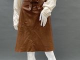 an image of a mannequin wearing a brown skirt and white shirt