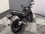 a motorcycle that is sitting on a checkered floor