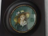 a picture of a picture of a girl in a hat on the wall