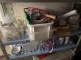 a shelf that has a lot of dishes and cups on it