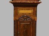 a wooden grandfather clock that is on display on the floor