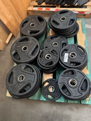 black cast iron weights sit on pallets in a warehouse