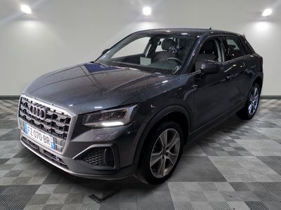 the new audi qx suv is parked in a showroom