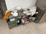 a metal cart with dishes on it in a kitchen