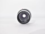 the lens of a camera on a white surface with a white background