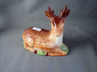 a figurine of a deer that is sitting on a table
