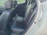 the back seats of a car with a dog in the passenger seat