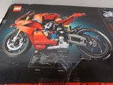 a box with a lego motorcycle in it on a table