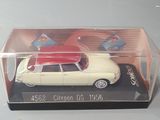 a toy car with a surfboard on top of it in a clear box