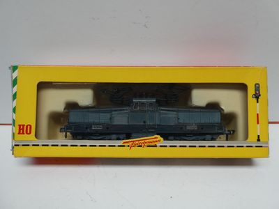 an image of a toy train in a box on a white surface