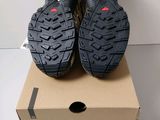 a pair of black hiking shoes sitting on top of a box