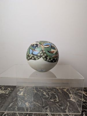 a vase that is sitting on top of a glass table