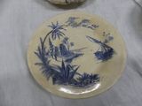 a blue and white plate with a picture of a boat on it