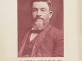 an old photo of a man with a beard in a suit