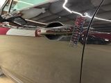 a close up of a car door handle with a sticker on it