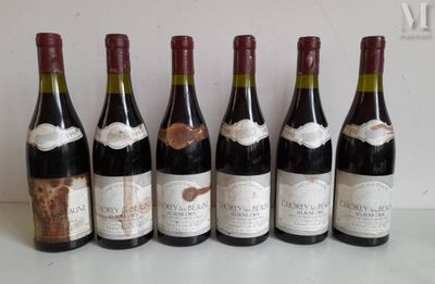 six bottles of wine are lined up in a row on a table