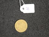 a gold coin and a tag on a black surface
