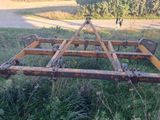 a rusted out plow sitting in the grass