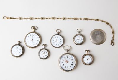 many different types of pocket watches displayed on the wall