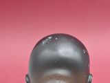 a small statue of a man with a bald head