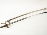 an old sword with a wooden handle on a white surface