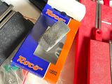 a box of sand sitting on a table next to a pair of clamps