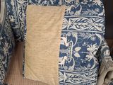 a blue and white chair with a pillow on top of it