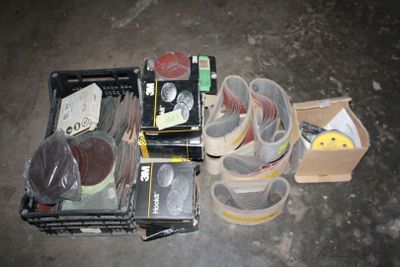 several pairs of shoes are sitting in a box on the floor