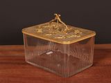 an image of a glass box with a gold decoration on it