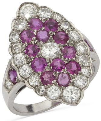 a close up of a pink and white diamond ring on a white background